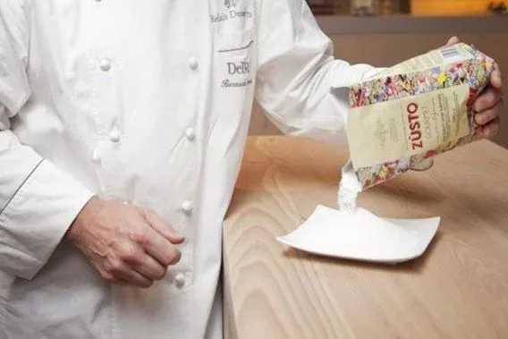 A chef pouring Zùsto from the pack