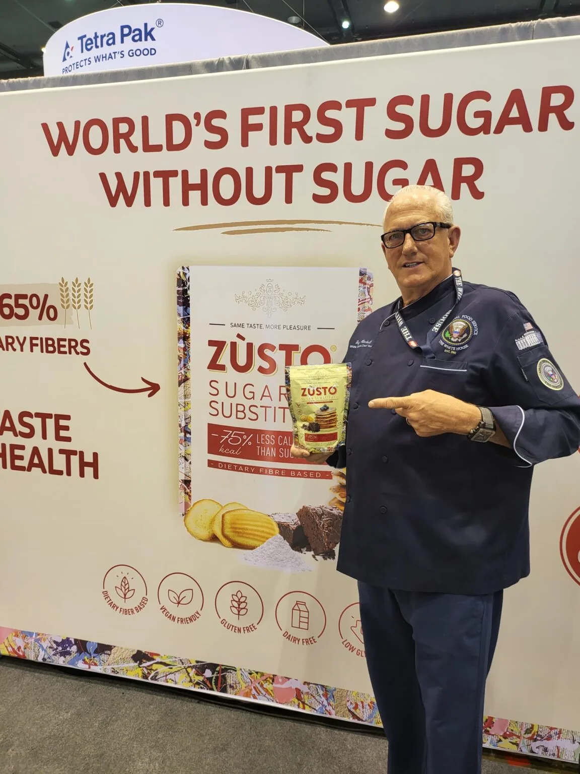 Chef holding a pouch of Zùsto sugar substitute at a trade fair