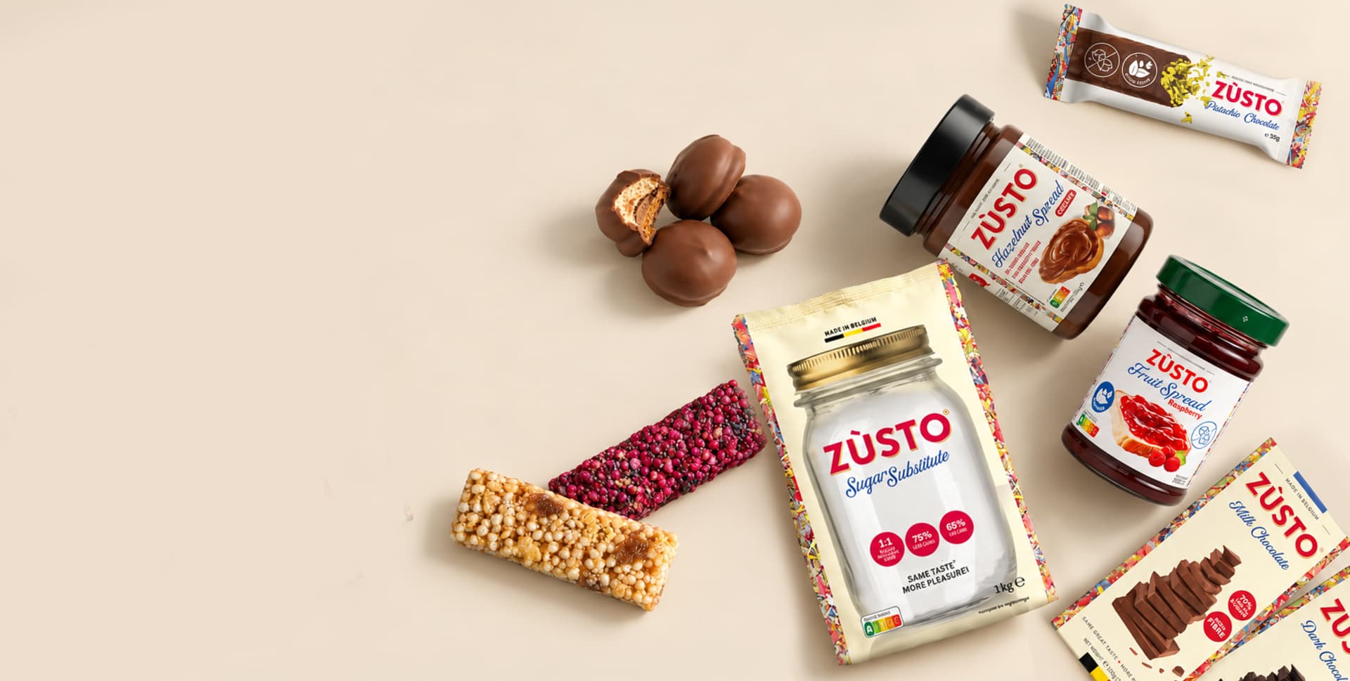 The Zùsto range on a bed of flour: milk and dark chocolate, a chocolate bar, Melocakes, puffed rice bars, hazelnut spread, raspberry fruit spread and sugar substitute