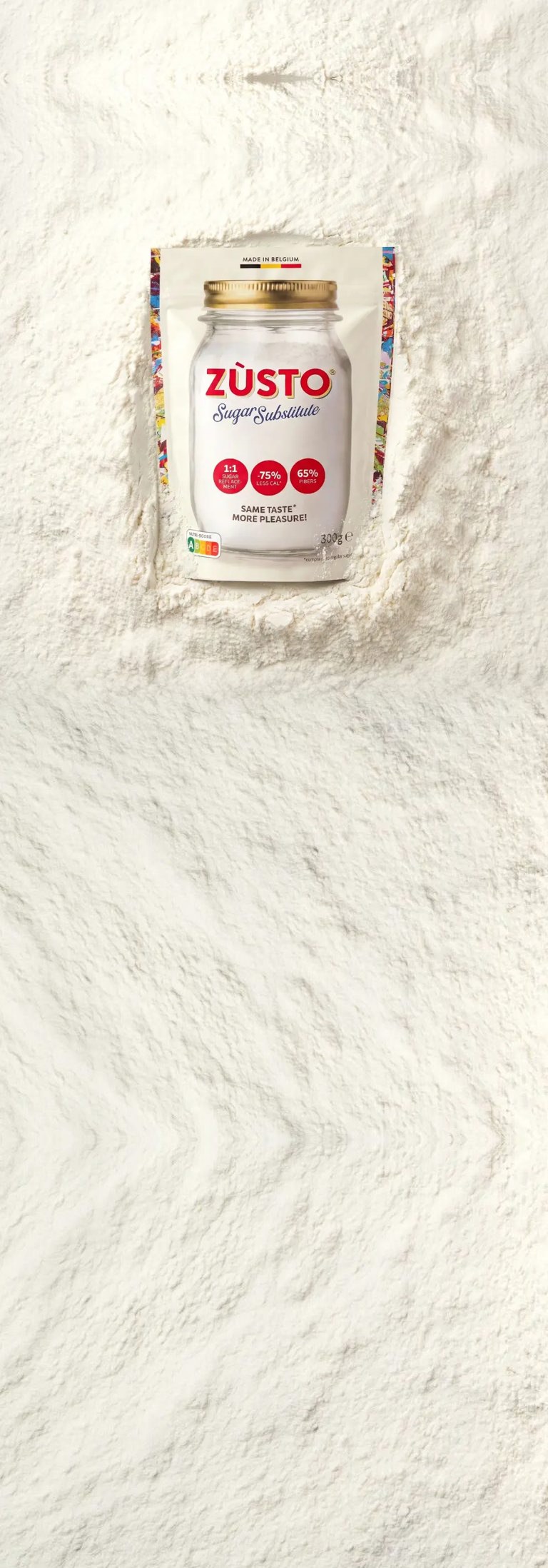 A pack of Zùsto sugar substitute pressed into a bed of fine white Zùsto powder